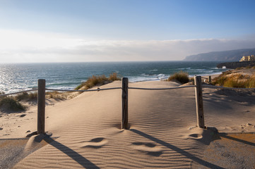 Fototapeta premium Sand dunes on the beach in Portugal, near Sintra, Guincho and Cascais