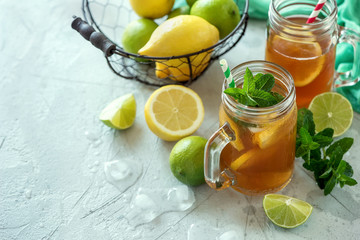 Iced tea, summer cold drink  with lemon and mint, limes and ice cubes, refreshment - 158907867