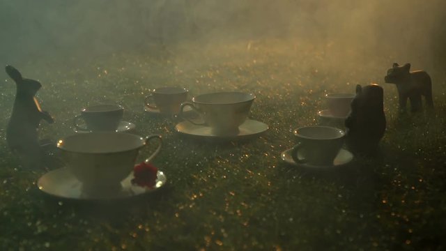 Fairy tea set on the grass in the smoke