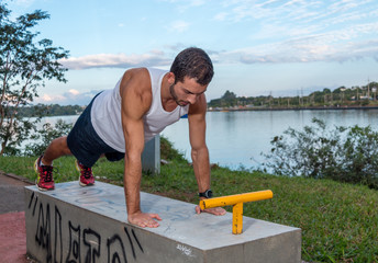 Young Man Working Out Outdoors Doing Push Ups