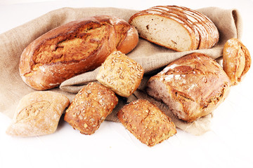 Different kinds of bread and bread rolls on board from above. Kitchen or bakery poster design.