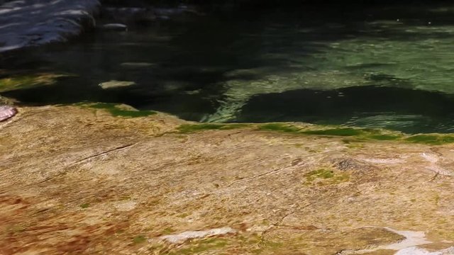 Man crosses a river barefoot