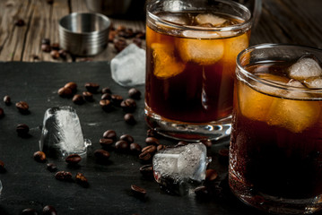Alcohol. Drinks, Boozy Black Russian cocktail with vodka and coffee liquor on rustic wooden table....