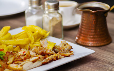 Close up of a delicious fresh mediterranean luch with fried chiken on a wooden table