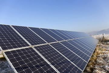 Solar Power Station in the snowy freeze winter Nature 