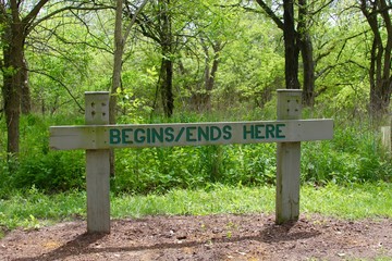 The small wood trail sign on a close up view,