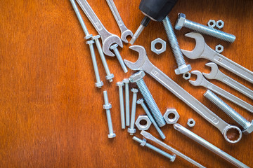 Plakat Wrench, Bolts and nuts on wood background