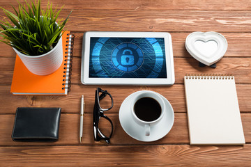 Web security and technology concept with tablet pc on wooden table