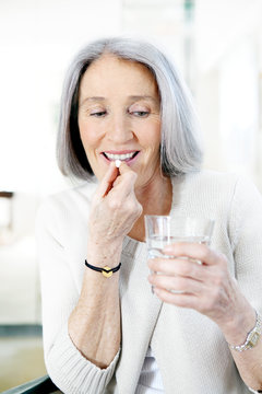 Elderly person taking medication