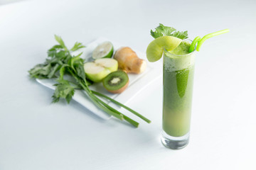 Healthy and fresh kiwi smoothie in glass on isolated white backhround