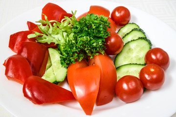Tasty vegetable cut from tomatoes, cucumbers and peppers, with herbs. Horizontal frame