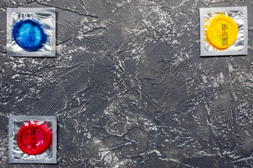 male contraception for safe sex with condoms on dark background top view mock up