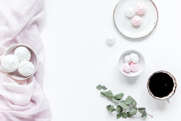 light breakfast with marsh-mallow and coffee on white table background top view space for text