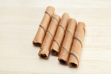 Chocolate sticks on wooden background