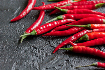 cooking sauce with red chili pepper on dark kitchen table background close up