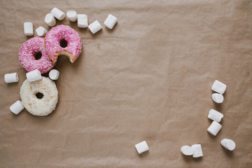 White marshmallow and donuts on a craft background