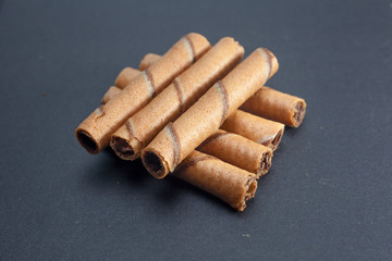 Chocolate sticks on black background