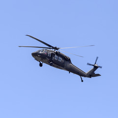 Fototapeta na wymiar Helicopter flying in the blue sky