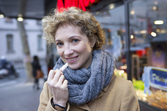 Woman Applying Lip Balm