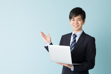 portrait of asian businessman isolated on blue background