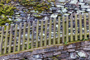 wooden fence at a drystone wall