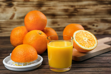 Fresh orange juice with fruits on table