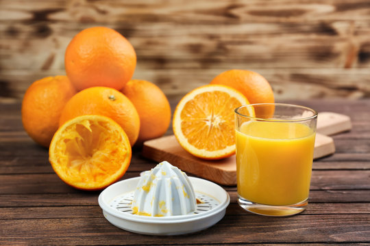 Fresh orange juice with fruits on table
