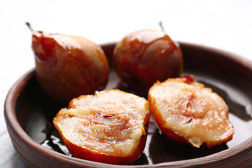 Baked pears with syrup served in wooden plate