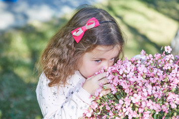 Little girl on nature with Flowers