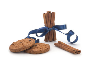 Oatmeal cookies with chocolate, cinnamon sticks on white background