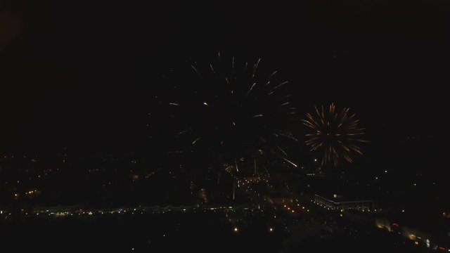 Aerial view Beautiful fireworks video from the drone in the night sky on celebration. Sparks. Fireworks are a class of explosive pyrotechnic devices used for aesthetic and entertainment purposes