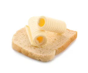Fototapeten Slice of bread with butter curls on white background © Africa Studio