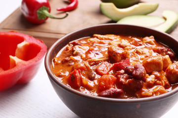 Bowl with delicious chili turkey on table