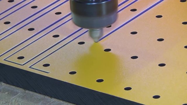 Milling cnc cuts the plastic panel hpl. The spindle of the automatic router moves from one object to another.