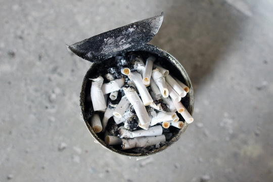 Heap of cigarette butts in an old can