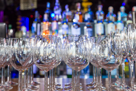 empty wine glasses with color blur background in bar