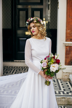 Woman with bunch and chaplet in dress