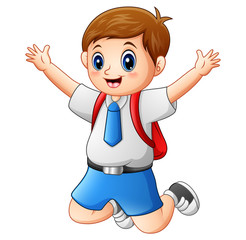 A cute boy in a school uniform is jumping