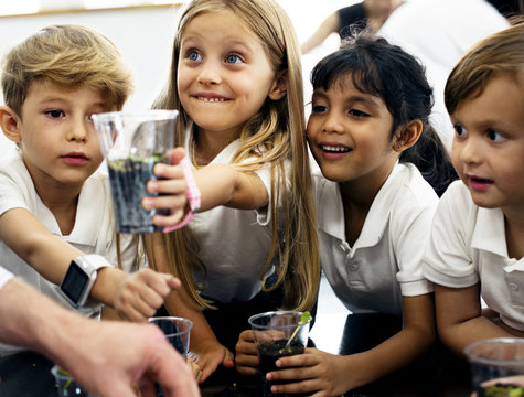 Group Of Diverse Kindergarten Students Learning Planting Experiment In Science Laboratory Class