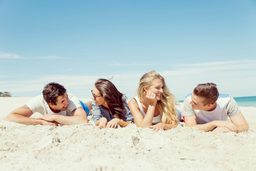 Fototapeta premium Company of young people on the beach