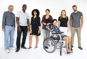 Group of people smiling with lady on wheelchair