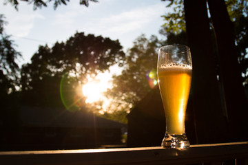 Beer in glass with sunset