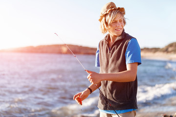 Teenage boy fishing at sea