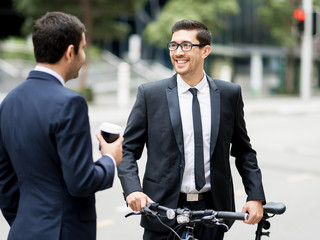 Fototapeta premium Young businessmen with a bike
