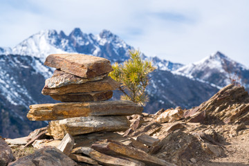 Cairns in the background of mountain peaks