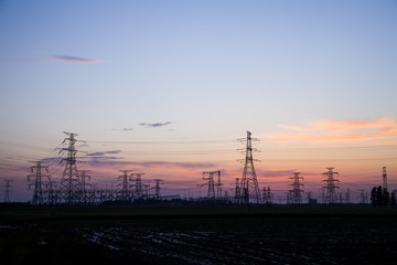 The silhouette of high voltage towers