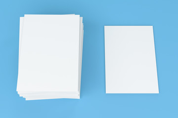 Stack of blank white closed brochure mock-up on blue background