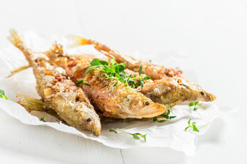 Tasty roasted smelt fish on white background