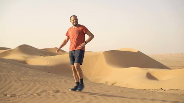 Young man walking on desert and searching for direction

