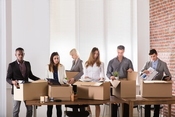 Businesspeople Packing Belongings In Cardboard Box